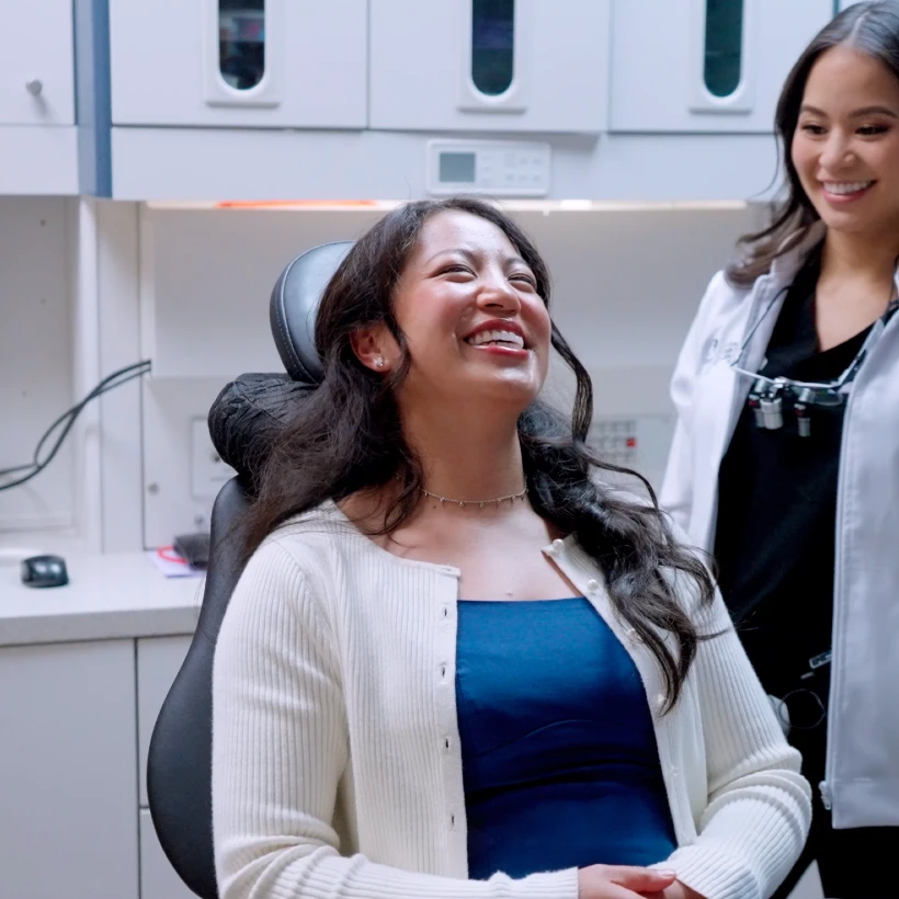 woman smiling comfortably at the dentist
